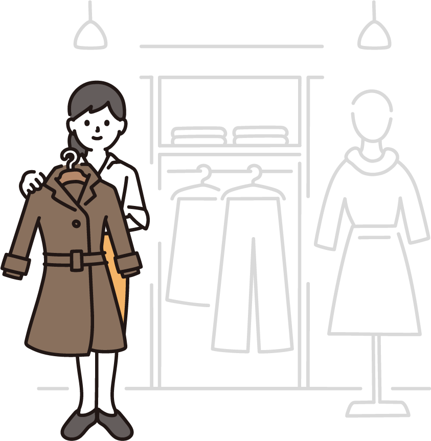 洋服店でコートを手に取りながら接客する女性スタッフ
